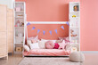 © Pixel-Shot - Stylish interior of children's room with baby bed