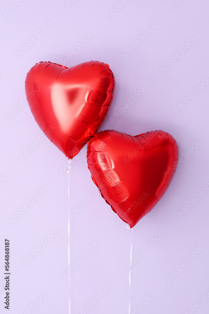 Heart shaped balloons for Valentine's Day on lilac background
