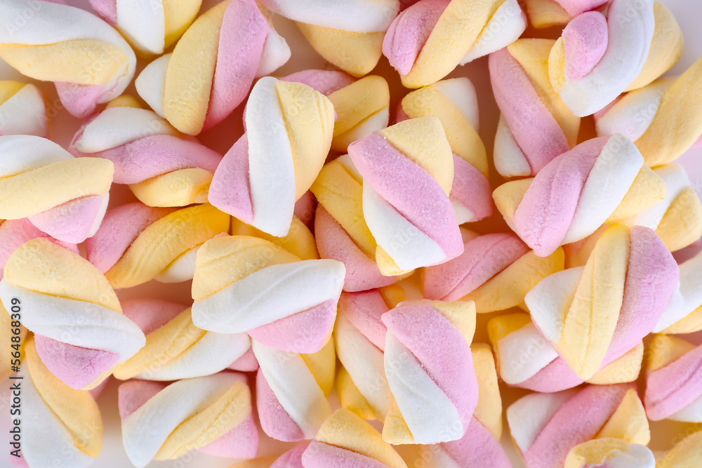 Tasty twisted marshmallows as background