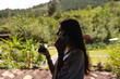 © Luis Herrera/Stocksy - happy woman on the phone drinking coffee