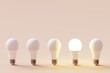 © Davide Illini/Stocksy - Many light bulbs on a pastel background. Concept 3d illustration.