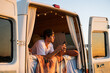 © Alba Vitta/Stocksy - Man with phone in camper van