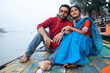 © Dream Lover/Stocksy - Young couple enjoying travel sitting on a boat over River Ganga,India