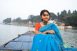 © Dream Lover/Stocksy - Young lady wearing traditional Sari sit on a boat over River Ganga