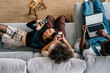 © Momento Estudio/Stocksy - asian girl smiling while looking at the mobile with her friends