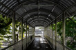 © Matt Hunt/Stocksy - A concrete path with bars on a skywalk bridge in Bangkok