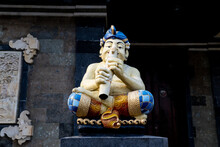 Balinese Statue Of A Man Playing A Flute