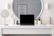 © Pixel Stories/Stocksy - Laptop on dressing table with wireless earbuds earphones. 3D render.