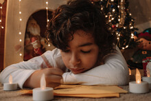 Portrait Of A Child Writing A Letter To Santa Claus