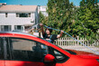 © ZQZ Studio/Stocksy - Young woman washing a red car