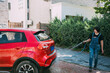 © ZQZ Studio/Stocksy - Young woman washing a red car