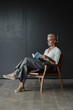 © Javier Pardina/Stocksy - business woman in her office reading a book