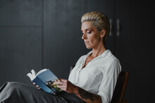 business woman in her office reading a book