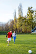 © Artem Podrez/Stocksy - A man and a woman play soccer