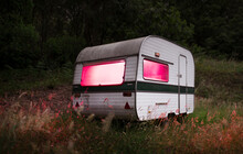 Caravan With Surreal Red Light In The Wilderness