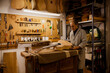 © VICTOR TORRES/Stocksy - Focused luthier working in workshop with a classic spanish guitar