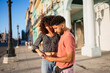 © Daniel Gonzalez/Stocksy - Cuban couple using smartphone on street together