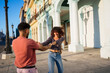 © Daniel Gonzalez/Stocksy - Cuban couple holding hands spinning around