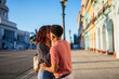 © Daniel Gonzalez/Stocksy - Cuban couple kissing during date