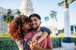 © Daniel Gonzalez/Stocksy - Happy Cuban couple hugging on street