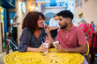 © Daniel Gonzalez/Stocksy - Man feeding girlfriend in sidewalk cafeteria