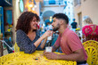 © Daniel Gonzalez/Stocksy - Happy couple with drinks in old town cafe