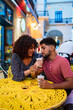 © Daniel Gonzalez/Stocksy - Woman giving drink to boyfriend