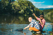 © Volodymyr - Mature senior man with friend fishing. Summer vacation. Happy cheerful people. Bearded men catching fish. Fisherman with fishing rod. Activity and hobby.