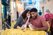 © Daniel Gonzalez/Stocksy - Cuban couple having date in street cafe