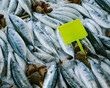 © Duet Postscriptum/Stocksy - Plenty of fresh fish on the counter with a bright plastic sign