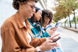 © Santi Nuñez/Stocksy - Girlfirends sending message on cellphone