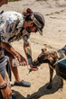 © Luis Herrera/Stocksy - man Gives water to his dog outdoors