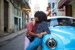 © Daniel Gonzalez/Stocksy - Cuban couple hugging near retro car