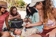 © Luis Herrera/Stocksy - best friends bonding with baby on a sunny beach day