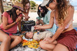 © Luis Herrera/Stocksy - best friends bonding with baby on a sunny beach day
