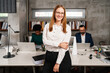 © Aleksandra Jankovic/Stocksy - Portrait Of A Smiling Businesswoman In The Office