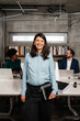 © Aleksandra Jankovic/Stocksy - Portrait Of A Smiling Pregnant Woman At The Workplace