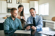 © Sean Locke/Stocksy - Financial Advisor Gives Clients Good News