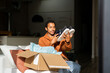© Alba Vitta/Stocksy - Man opening delivery box from second hand shop