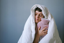 Young Woman With A Warm Blanket  And Water Heating Pad. 