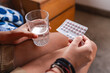 © Luis Herrera/Stocksy - woman taking birth control pills