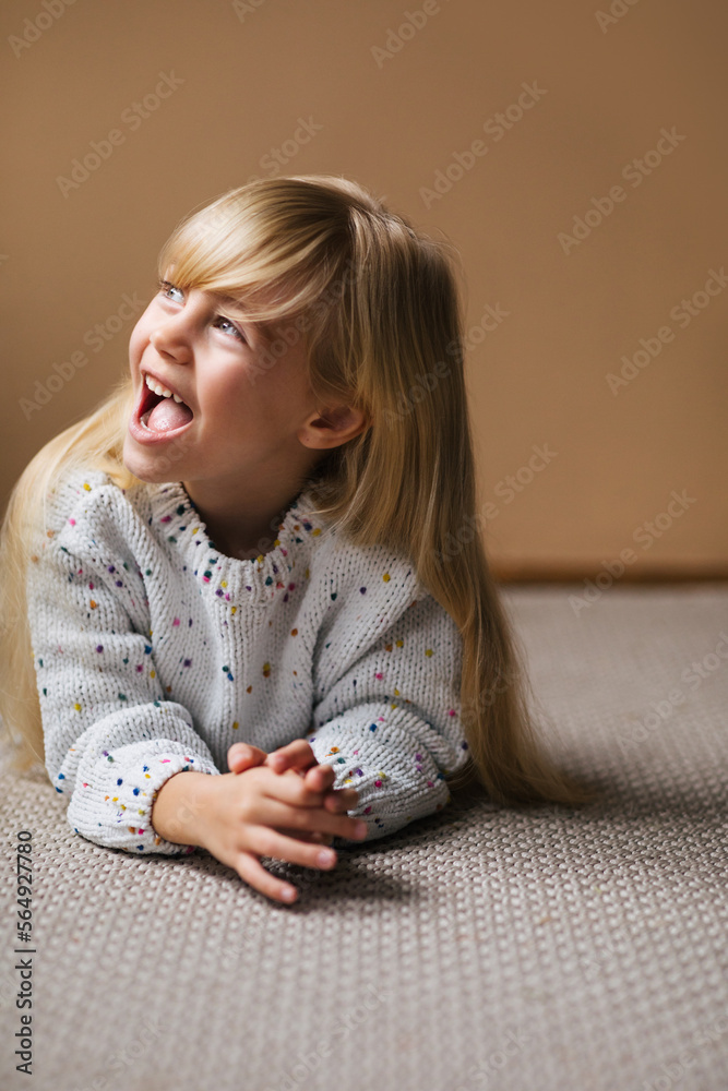 Little Girl Lying on Floor and Smiling Stock Photo | Adobe Stock