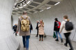 © Hernandez & Sorokina/Stocksy - Person Using Phone Between Walking People