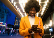 © Hernandez & Sorokina/Stocksy - Woman Using Phone Outdoors At Night
