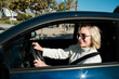 © Malquerida Studio/Stocksy - Cheerful woman driving a car