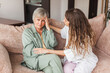 © Tatyana Gladskih - Grown up daughter soothe aged mother holds her hand feel empathy give her moral support, sad elderly woman at home