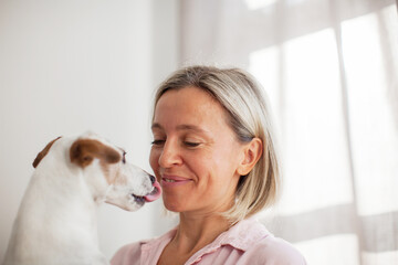 Wall Mural - Dog kissing or licking woman