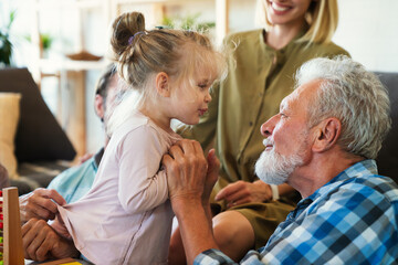 Cheerful multi-generation family having fun while spending time together at home.