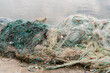 © Ezequiel Giménez/Stocksy - Heap of fishing nets in port