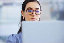Business Woman, Glasses And Working On Laptop In Office, Agency And Startup Company. Focus, Face And Female Worker On Computer Technology For Email, Internet Planning And Professional Seo Research